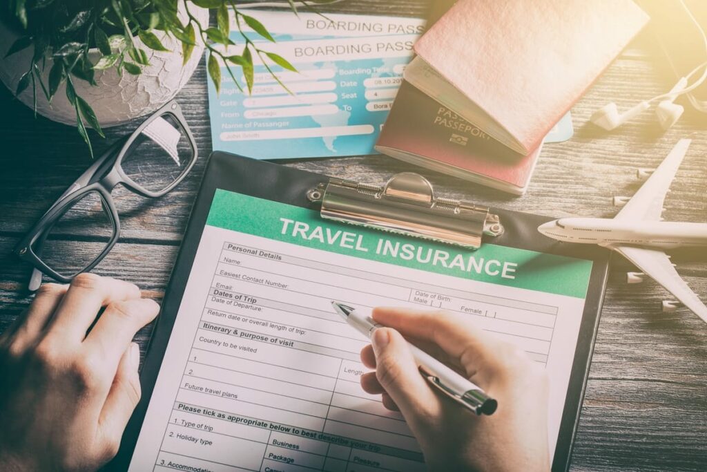 Person completing a travel insurance document